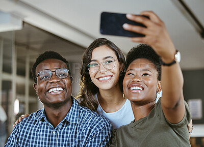 Buy stock photo Group of young cheerful businesspeople taking a selfie together at work. Happy african american businesswoman taking a picture with her colleagues on her phone in an office