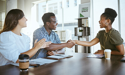 Buy stock photo Young happy businesspeople shaking hands in a meeting with a colleague clapping at work. Cheerful hispanic businesswoman clapping for coworkers shaking hands