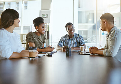 Buy stock photo Group of diverse businesspeople having a meeting in an office at work. Happy mixed race businessman talking during a workshop at a table with coworkers. Businesspeople planning together