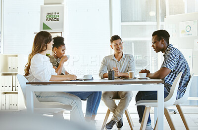 Buy stock photo Group of diverse businesspeople having a meeting in an office at work. Happy african american businessman talking during a workshop at a table with coworkers. Businesspeople planning together