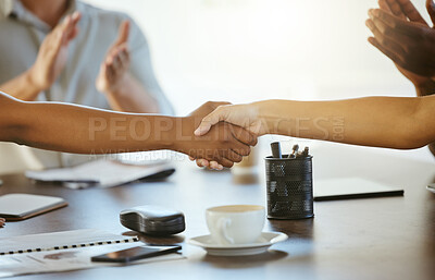 Buy stock photo Two businesspeople shaking hands while in an office together at work. Business professionals greeting and making deals with each other in a meeting. Boss hiring an employee