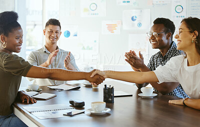 Buy stock photo Two businesswoman shaking hands in a meeting at work. Business professionals greeting and making deals with each other. Hispanic boss hiring an employee in an interview