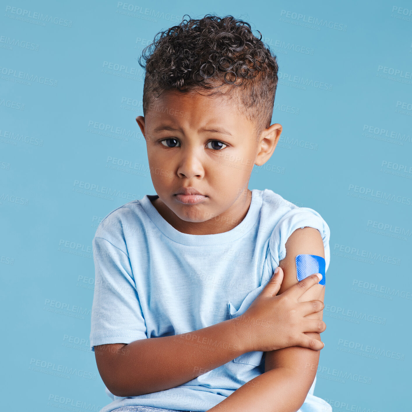 Buy stock photo Portrait, sad and kid with arm bandage in studio isolated on a blue background. Face, upset and child with plaster after vaccine, injury or wound for healthcare wellness, first aid or medical help.