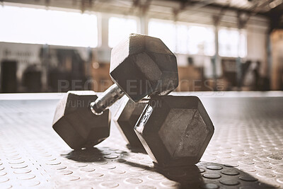 Buy stock photo Neat dumbells on the gym floor.Workout equipment in empty gym. Bodybuilding equipment in the gym. Heavy weight make for better bodybuilding. Strength training requires dumbells.