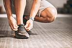 Hands of a fit man tying laces. Bodybuilder tying his shoe laces. Athletic man getting ready to workout. Fit man tying his sneaker laces. Trainer tying his laces cropped.
