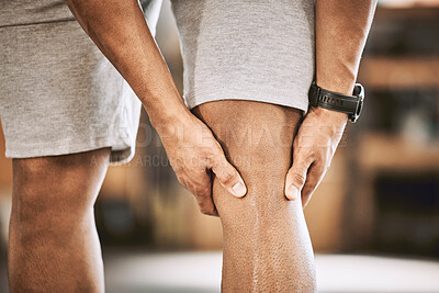 Buy stock photo Closeup of fit man with a hurt knee. Hands of athlete holding a problem knee joint. Muscular bodybuilder with knee injury. Strong trainer with a knee muscle cramp. Exercise can be painful