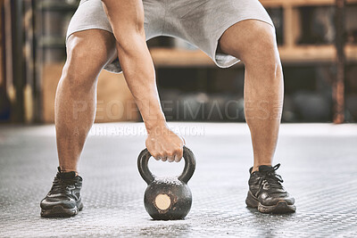 Buy stock photo Fit athlete lifting a heavy kettlebell. Strong bodybuilder doing an arm exercise. Bodybuilder lifting weights in the gym cropped. Bodybuilding endurance strength training builds strong muscle