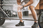 Hands of bodybuilder dusting before lifting weights. Fit athlete using powder on their hands before training. Use chalk before lifting weights for strength. Strong, sporty trainer preparing to workout