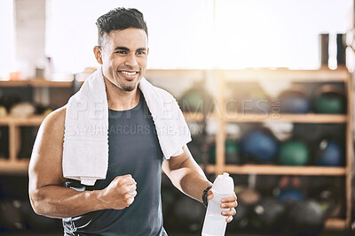 Buy stock photo Happy trainer cheering in the gym. Fit, strong man taking a break from his workout. Bodybuilder using a towel after his exercise routine. Sporty athlete enjoying his workout routine.