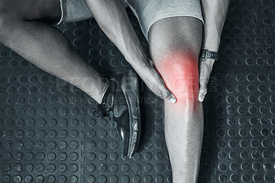 Buy stock photo Joint ache is common in the gym. Trainer touching their knee in pain from above. The knee joint is prone to injury. Closeup of athlete in pain at the gym. CGI red spot of pain on trainers knee