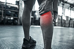 Pain in the calf from injury hurts. Hands of trainer touching their leg in pain. Bodybuilder with CGI pain in their leg. Closeup on hand of athlete with physical injury at the gym