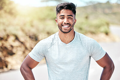 Buy stock photo Portrait of happy young mixed race man getting ready to workout. Young hispanic man smiling and standing with his hands on his hips outside. Getting fitter with each day of running and exercise