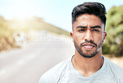 Buy stock photo Portrait athletic young mixed race man looking serious while standing outside. Handsome hispanic male looking focused and determined while exercising, working out and getting fit outdoors