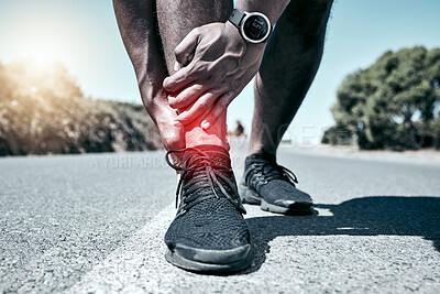 Closeup fit mixed race man holding his ankle in pain while exercising outdoors. Unrecognizable male athlete suffering with a joint injury highlighted by glowing cgi. You can get hurt during a workout