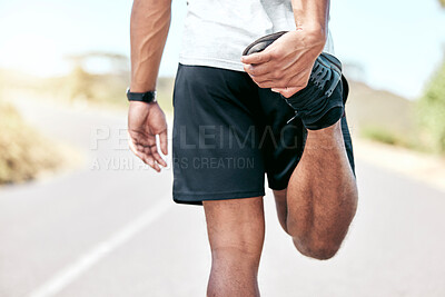 Rearview fit young mixed race man stretching before his exercise outdoors. Closeup male warming up and getting ready in preparation for a run or jog outside in nature. Endurance and cardio training