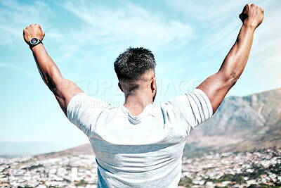 Buy stock photo Rearview fit mixed race man celebrating a victory with his arms raised. Athletic male feeling overjoyed and cheerful after a win. Finding success with hardwork and dedication to health and fitness