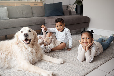 Buy stock photo Two young mixed race siblings playing on the lounge floor with their adopted dog. Two adorable children bonding with an animal rescue at home