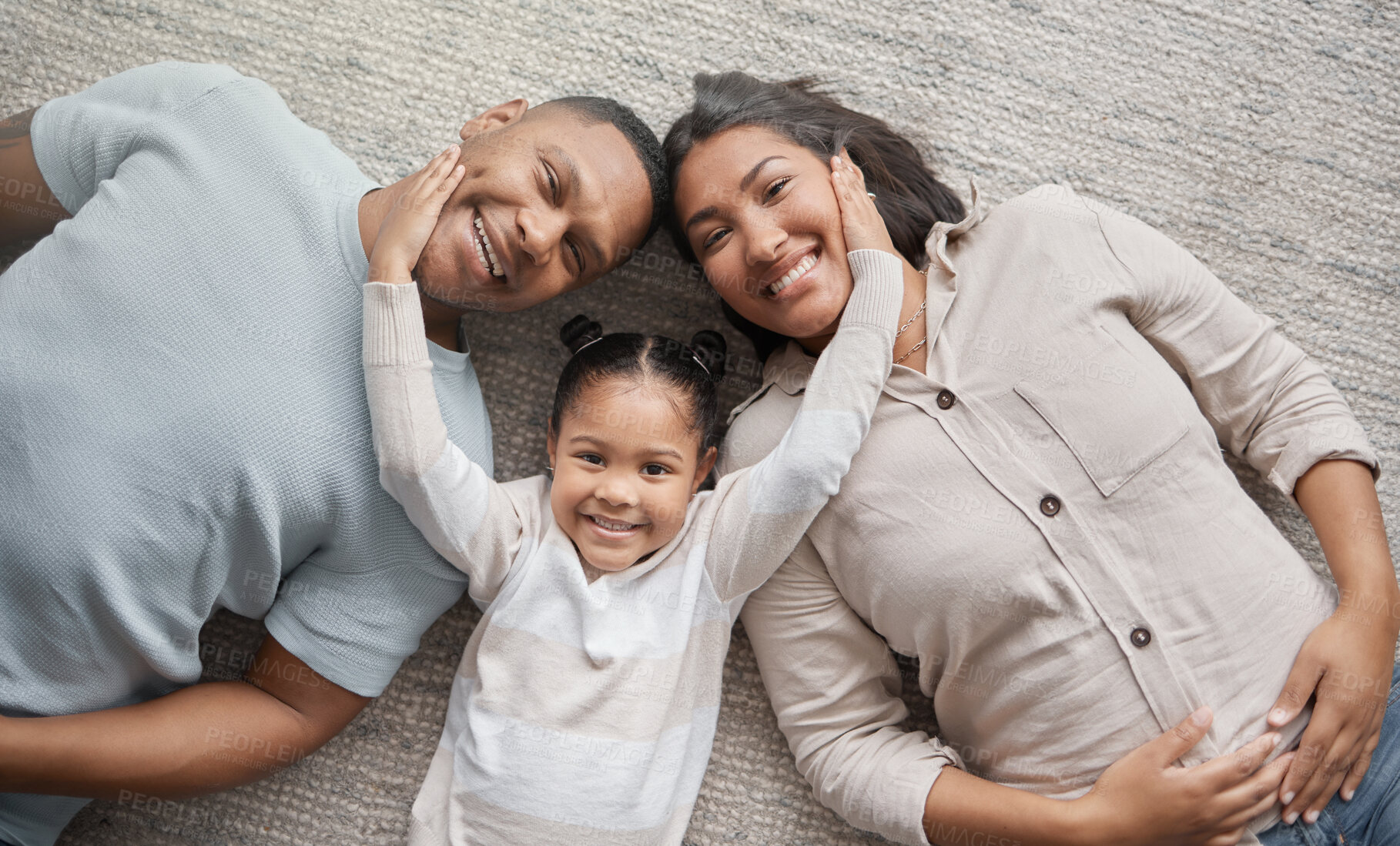 Buy stock photo Top view, mom and dad with portrait of happy child for love, care and bonding of quality time together at home. Face of mother, father and girl kid relax with family in house for fun, smile and play