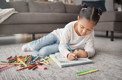 Buy stock photo Young girl, kid and pencils on floor with coloring book in living room for education, learning or creative development. Cute child, books and crayons for writing, drawing or creativity of art project