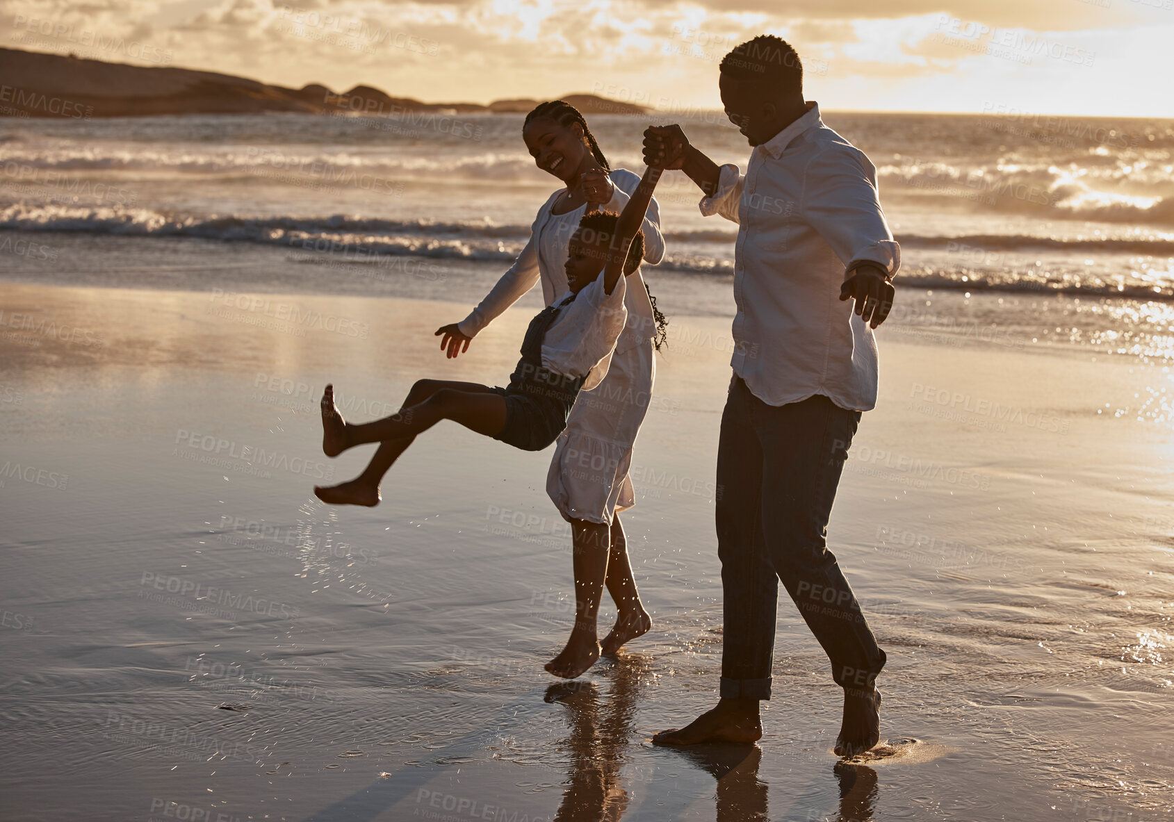 Buy stock photo Holding hands, swing and walking with black family on beach together for holiday, travel or vacation. Love, nature or water with mother, father and son in ocean or sea for bonding, fun and wellness