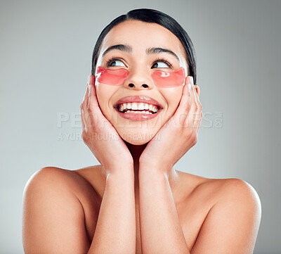 Buy stock photo A beautiful happy mixed race woman wearing under eye patches. Hispanic model with glowing skin using hydrating treatment against a grey copyspace background
