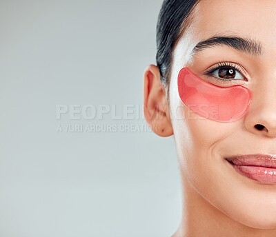 Buy stock photo Studio closeup portrait of a beautiful mixed race woman wearing under eye patches. Hispanic model with glowing skin using hydrating treatment against a grey copyspace background
