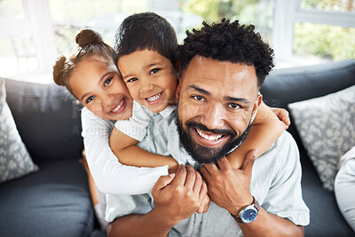 Happy young mixed race dad bonding with his adorable children in a living room at home. Cute Hispanic son and daughter hugging their single father affectionately while playing on a sofa in the lounge.