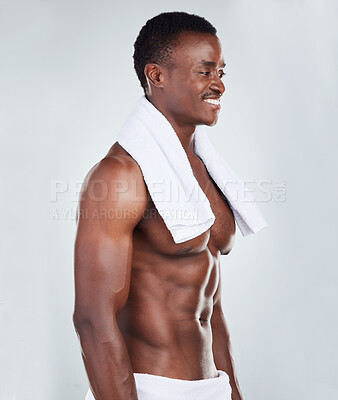 Buy stock photo One African American fitness model posing topless in a towel and looking muscular. Confident black male  athlete isolated on grey copyspace in a studio after a shower