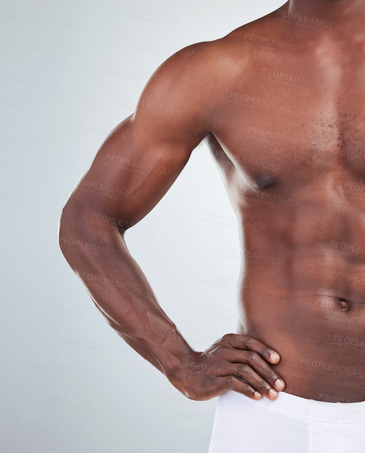 Buy stock photo Closeup of one African American fitness model posing topless in a underwear and looking muscular. Confident black male athlete isolated on grey copyspace in a studio wearing boxers showing his sixpack