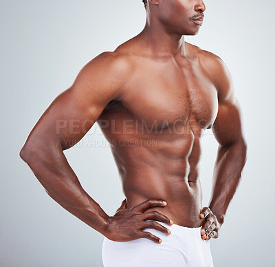 Buy stock photo Closeup of one  African American fitness model posing topless in a underwear and looking muscular. Confident black male athlete isolated on grey copyspace in a studio wearing boxers