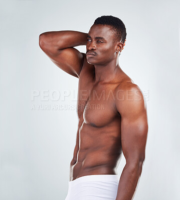 Buy stock photo One African American fitness model posing topless in underwear and looking muscular. Confident black male athlete isolated on grey copyspace in a studio wearing boxers