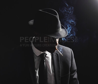 Buy stock photo Man, gangster and cigarette in studio by black background with smoke, silhouette and dangerous in shadow. Mafia, secret agent or male in night for smoking with vintage aesthetic by dark backdrop