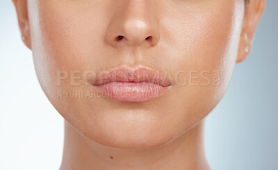 Buy stock photo Closeup of perfect lips on unknown woman in studio. Caucasian model with smooth glowing skin isolated against a grey background and posing. Woman with healthy luscious plump lips and routine lip care