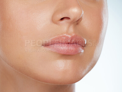 Buy stock photo Closeup of perfect lips on unknown woman in studio. Caucasian model with smooth glowing skin isolated against a grey background and posing. Woman with healthy luscious plump lips and routine lip care