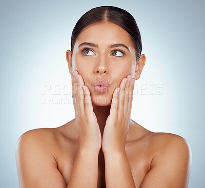 Buy stock photo Playful beautiful woman with smooth glowing skin and copyspace posing topless and touching her face. Thinking confident caucasian model isolated against a grey studio background and making silly faces