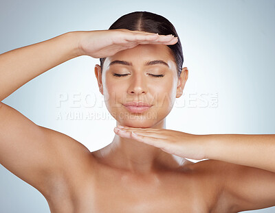Buy stock photo Beautiful woman with smooth glowing skin and copyspace posing topless and framing her face with hands. Caucasian model isolated against grey studio background. Healthy skincare and self care routine