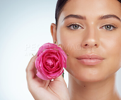 Buy stock photo Skincare, face and woman with rose in studio isolated on a white background. Portrait, natural flower and serious female model with pink floral plant for makeup cosmetics, beauty treatment or organic