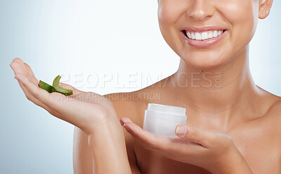 Buy stock photo Closeup of smiling unknown woman using aloe vera in her skincare routine. Caucasian model isolated against grey studio background and posing with copyspace. Organic plants for hydration and moisture