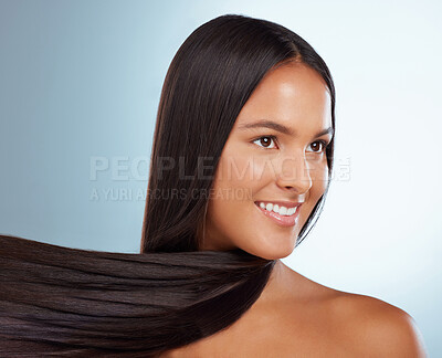 Buy stock photo A hispanic brunette woman with long lush beautiful hair posing and smiling against a grey studio background. Mixed race female standing showing her beautiful healthy hair