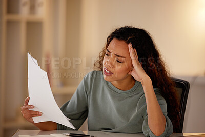Buy stock photo Young woman looking stressed while going through paperwork alone in an office at night. One female only looking worried while struggling with her budget and finances. Burnout from deadlines