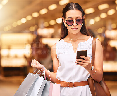 Buy stock photo Shopping bag, mall and a woman typing on a phone for fashion, sale or influencer discount deal. Customer person with sunglasses, retail bags and smartphone for online promotion or social media app