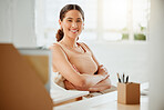 Portrait of one confident young hispanic business woman sitting with arms crossed while working in an office. Happy and ambitious entrepreneur ready for success in a creative startup agency