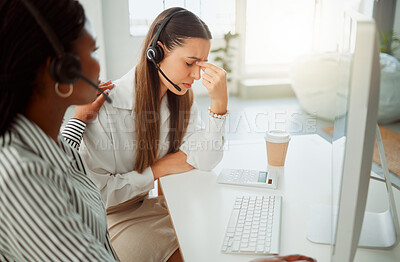 Buy stock photo Stressed young hispanic call centre agent looking worried and suffering with headache while being comforted and consoled by a colleague in an office. Woman offering sympathy and support to frustrated and upset coworker
