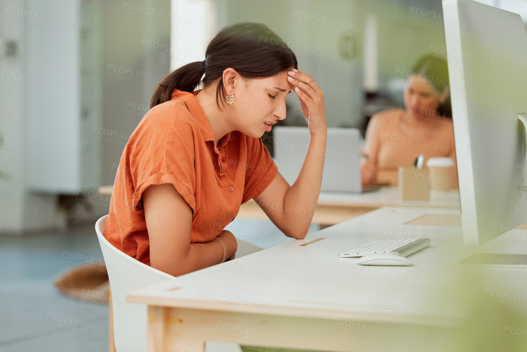 Buy stock photo One hispanic business woman suffering with headache and holding sore tummy while feeling ill with menstrual stomach cramps in an office. Hungry employee on period getting sick, bloated and uncomfortable with digestive pain caused by stress and anxiety