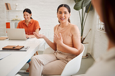 Young hispanic business woman speaking to colleagues during a meeting in an office boardroom. Staff sharing feedback and explaining ideas while brainstorming in a creative startup agency