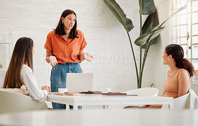 Buy stock photo Young hispanic business woman using a laptop while leading a presentation to colleagues during a meeting in an office boardroom. Staff sharing feedback and explaining ideas while brainstorming in a creative startup agency