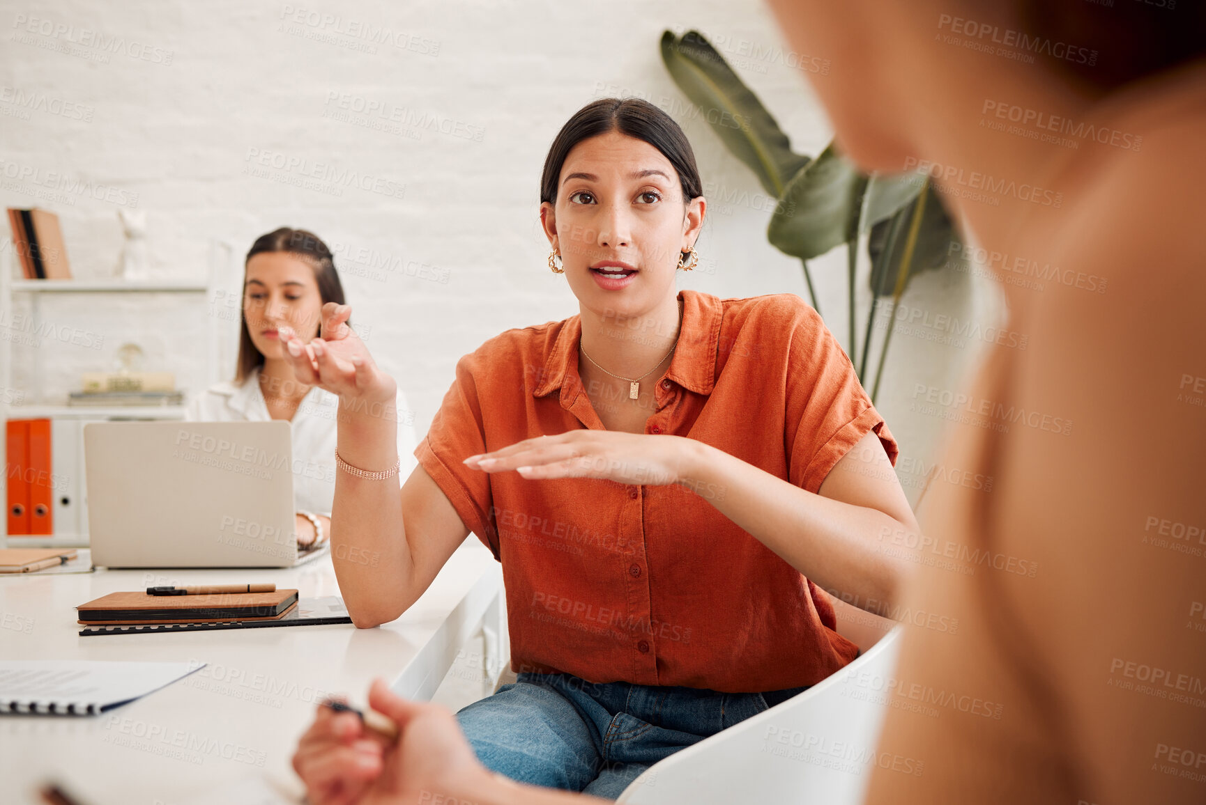 Buy stock photo Young hispanic business woman speaking to colleagues during a meeting in an office boardroom. Staff sharing feedback and explaining ideas while brainstorming in a creative startup agency