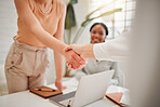 Closeup of hispanic businesswoman shaking hands with colleague during a meeting in an office. Motivated woman finalising a successful promotion, deal and merger. Coworkers greeting while collaborating in a creative startup agency