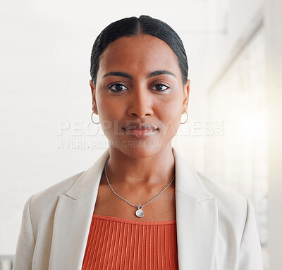 Buy stock photo Young mixed race businesswoman standing alone in an office at work. Face of one confident hispanic businessperson looking serious standing at work
