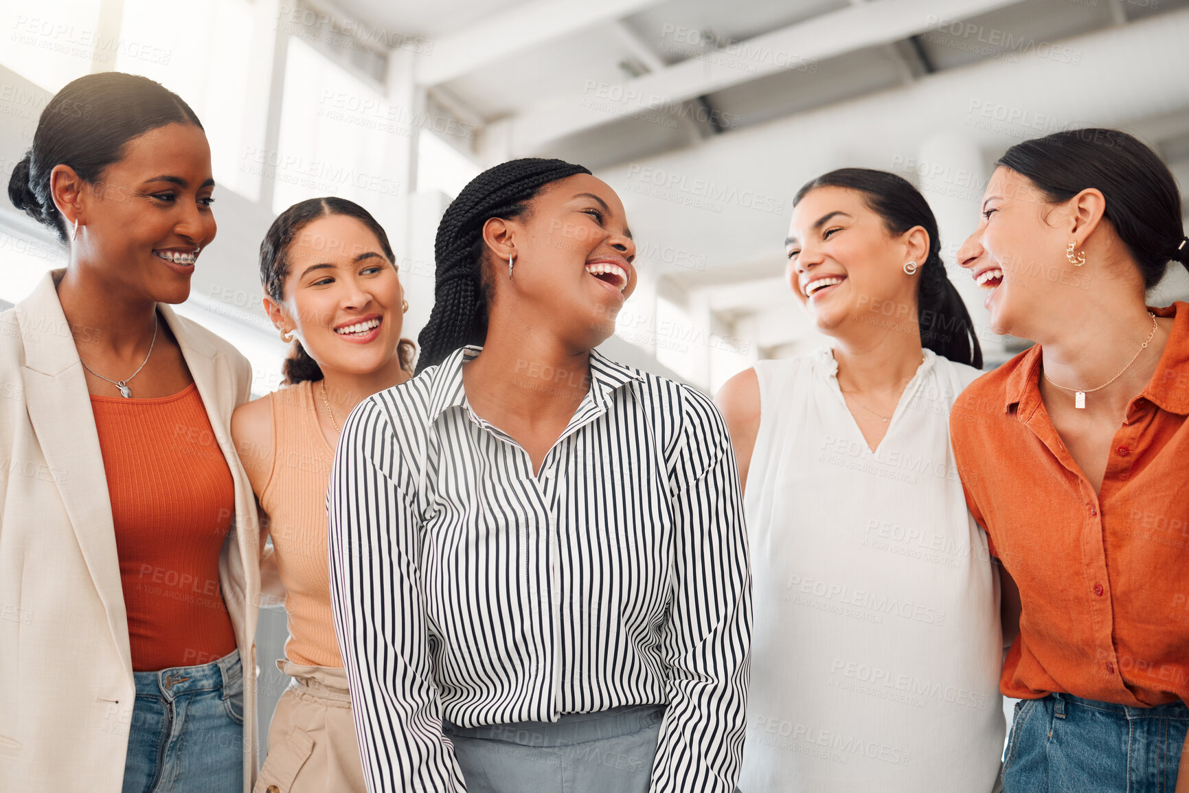 Buy stock photo Diverse group of five happy businesswomen having a meeting together in at work. Joyful businesspeople talking and laughing while standing in an office